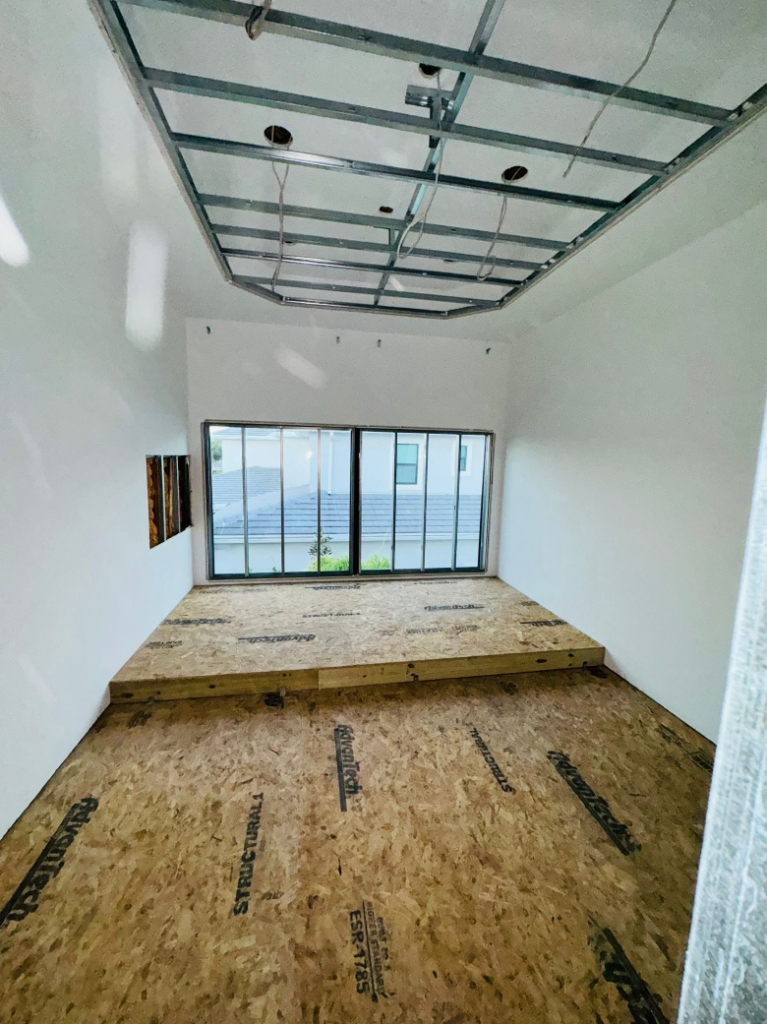 Bright, finished living space with large windows after a home remodel
